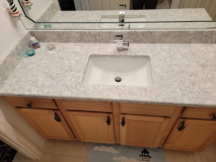 Bathroom vanity countertop with undermount sink and matching backsplash