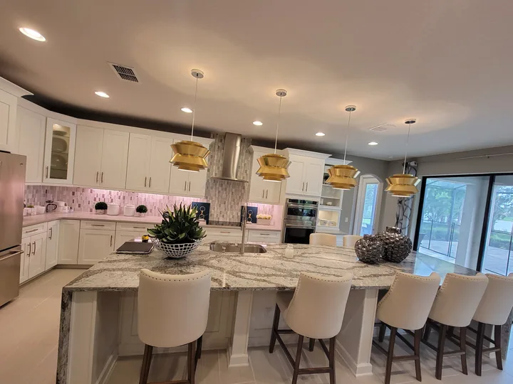 Wide kitchen view with a Cambria Seagrove island and light perimeter countertops