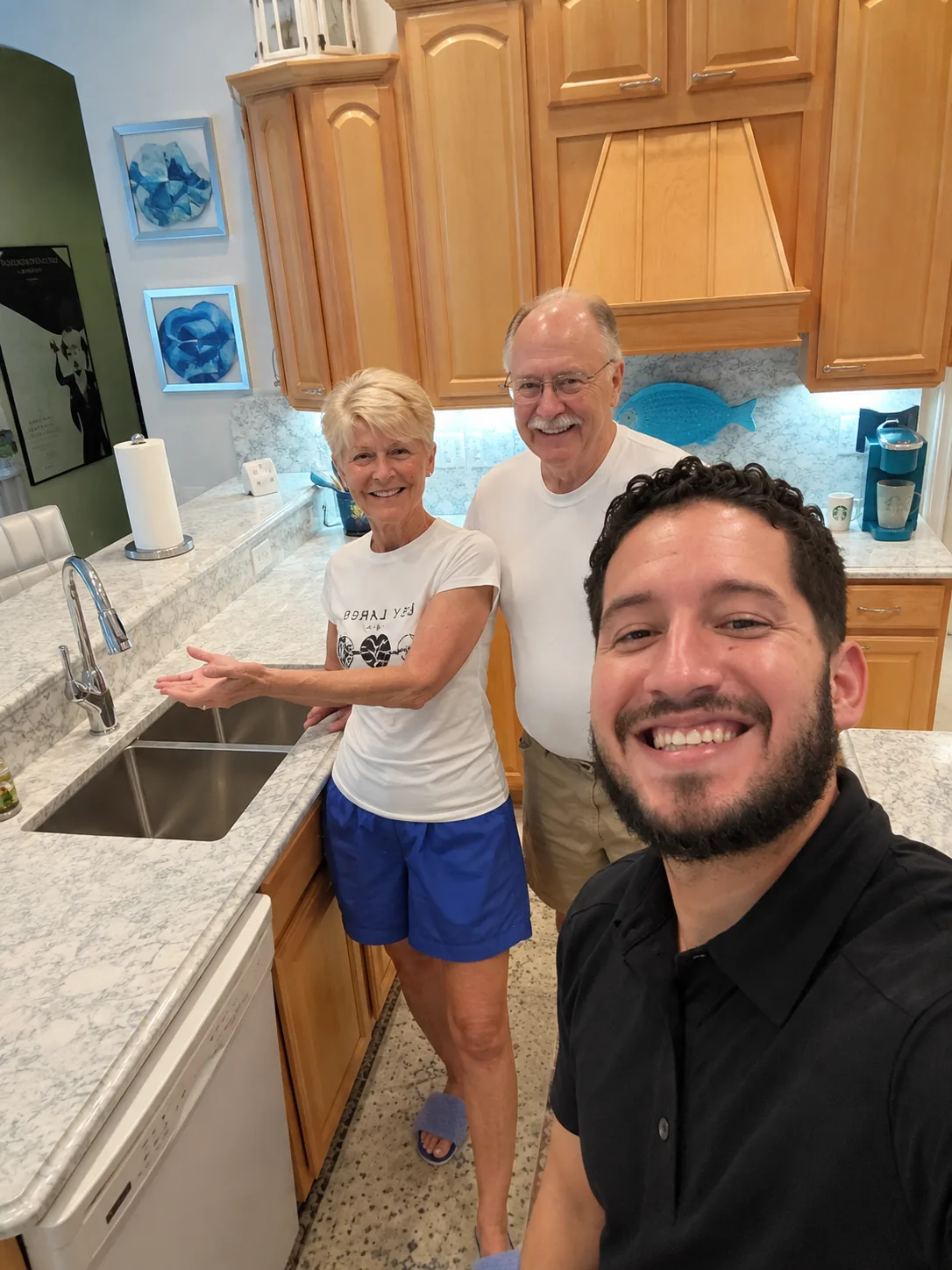 Tampa Bay Quartz Countertops representative with customers in their completed Cambria Montgomery kitchen