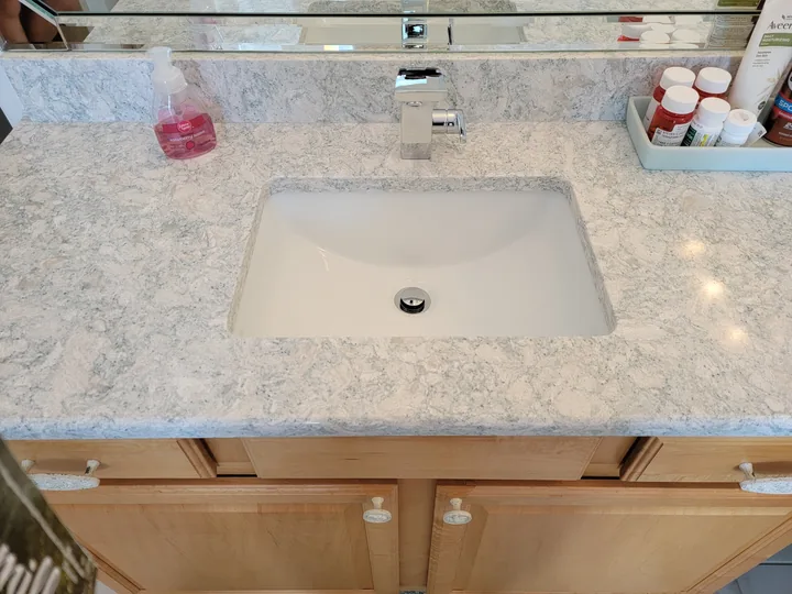Close view of an undermount vanity sink and finished countertop