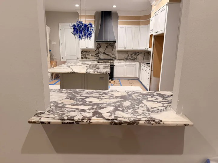Veined stone kitchen, island and backsplash in Clearwater