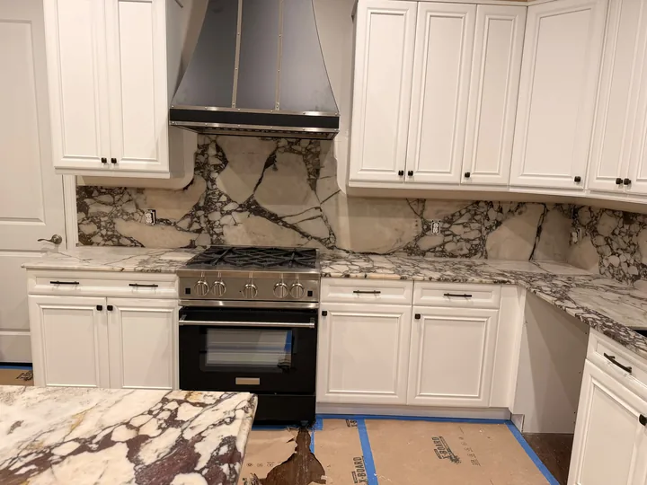 Stone countertops and full-height range backsplash in Clearwater