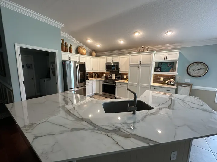 Completed kitchen island with dramatic veined stone countertop