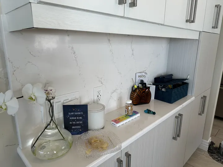 White quartz countertop with matching full-height backsplash