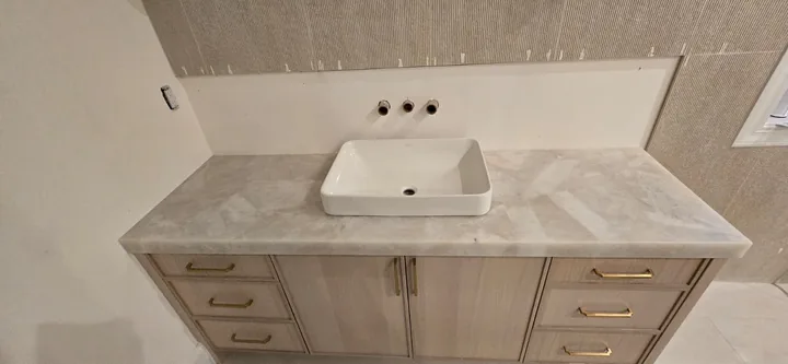 Light stone vanity with vessel sink in St. Petersburg