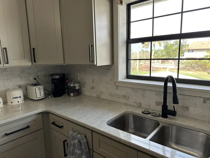 Light stone kitchen countertop with double-bowl sink