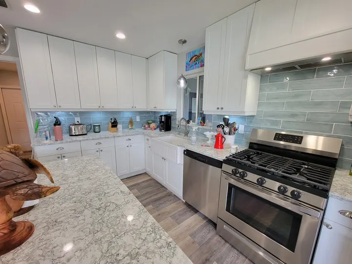 White kitchen with patterned stone countertops and island