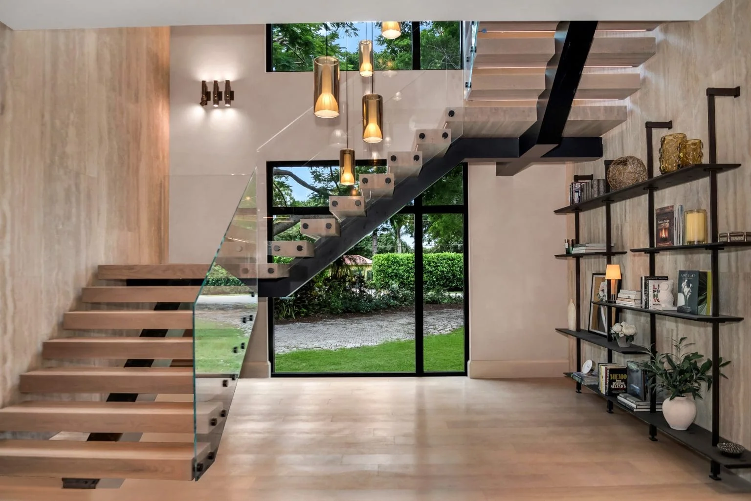Floating staircase beside travertine feature wall