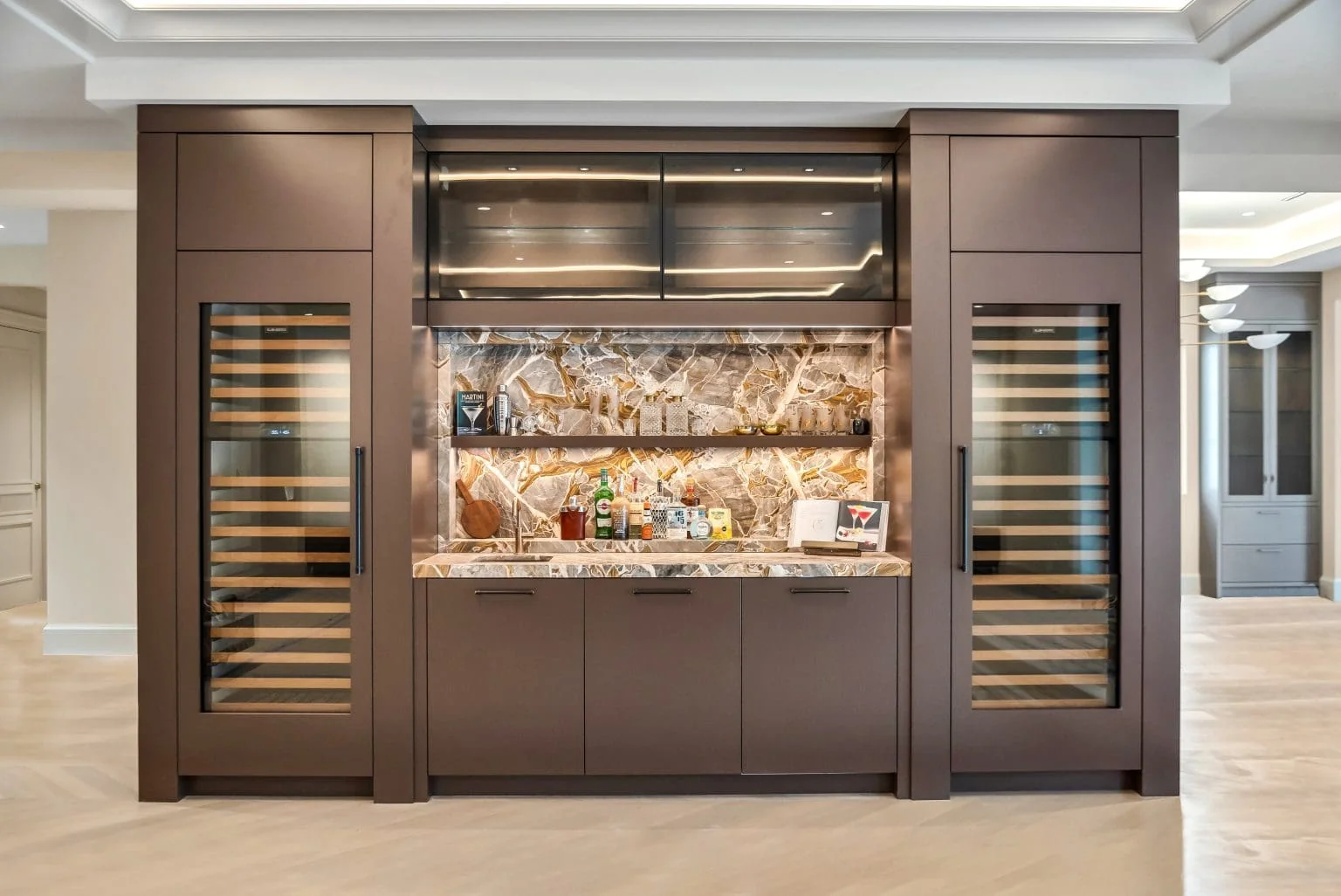 Custom wet bar with illuminated Luci D'Oro stone backsplash